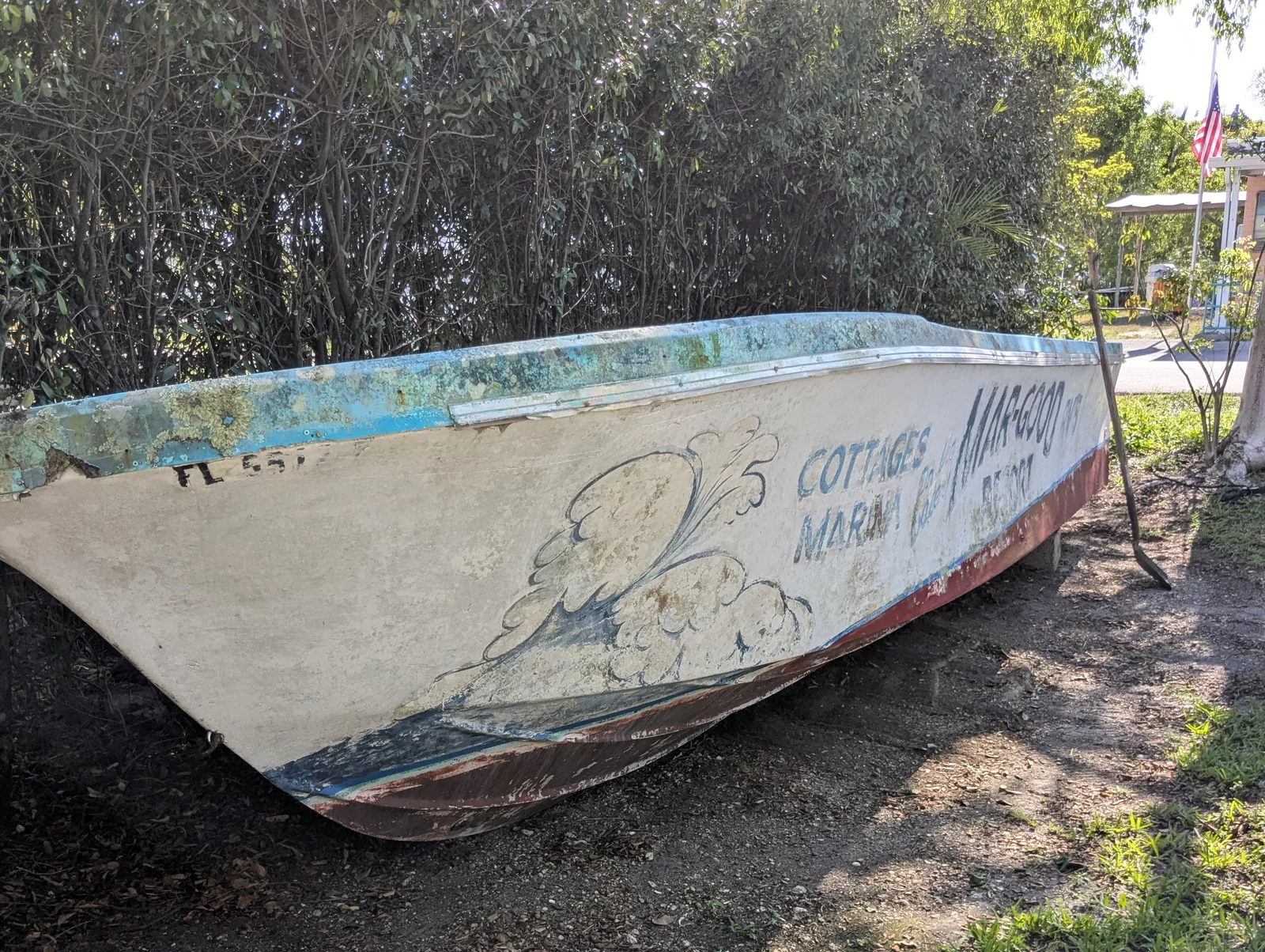 margood-boat-faded-original-paint The little Mar-Good boat at the west entrance to MarGood Harbor Park in Goodland with faded, barely legible original paint before restoration