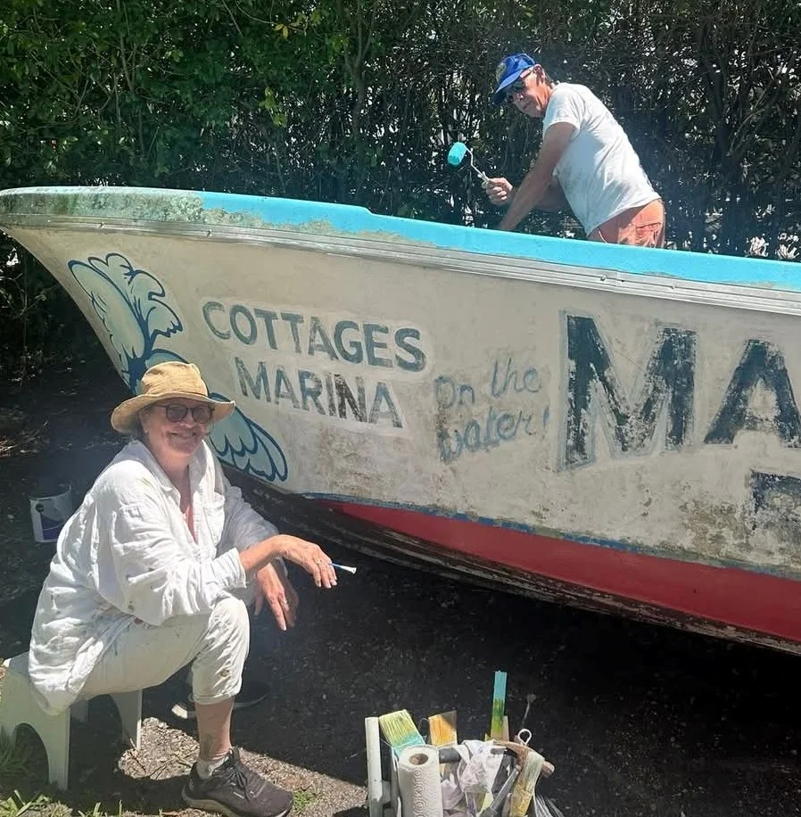 tara-oneill-jim-seegers-painting-margood-boat Tara O'Neill working on the painted waves and lettering of the Mar-Good boat while Jim Seegers paints the topside in Goodland
